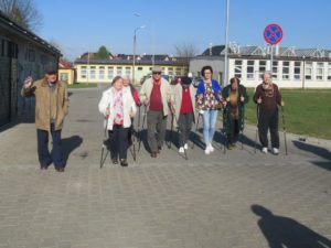 seniorzy Dziennego Domu Pomocy dla Osób Starszych w Jaśle spacerują z kijkami do nordic walking