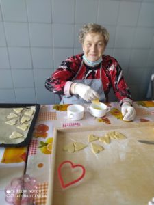 seniorka Dziennego Domu przygotowuje kruche ciasteczka, na zajęciach kulinarnych