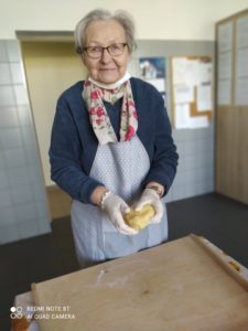 seniorka przygotowuje ciasto na zajęciach kulinarnych w Dziennym Domu Pomocy